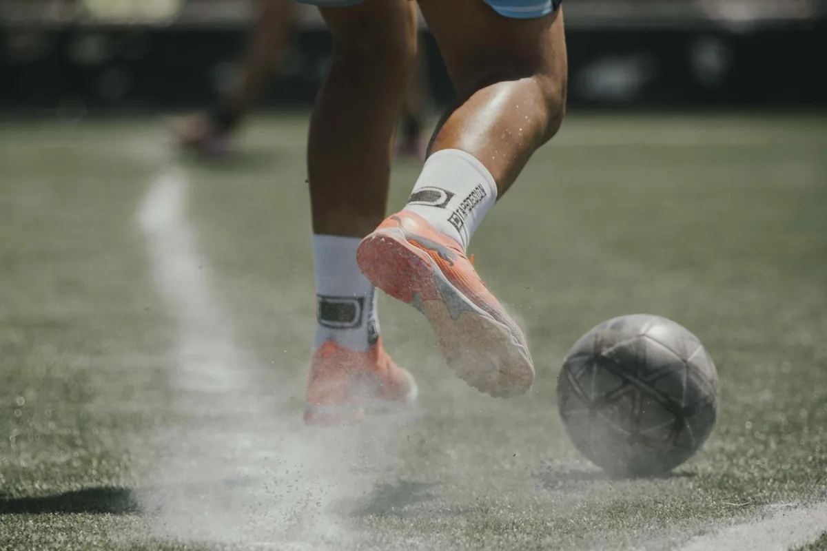 Close view of football boots and the ball on the pitch at the 2026 Champions Cup