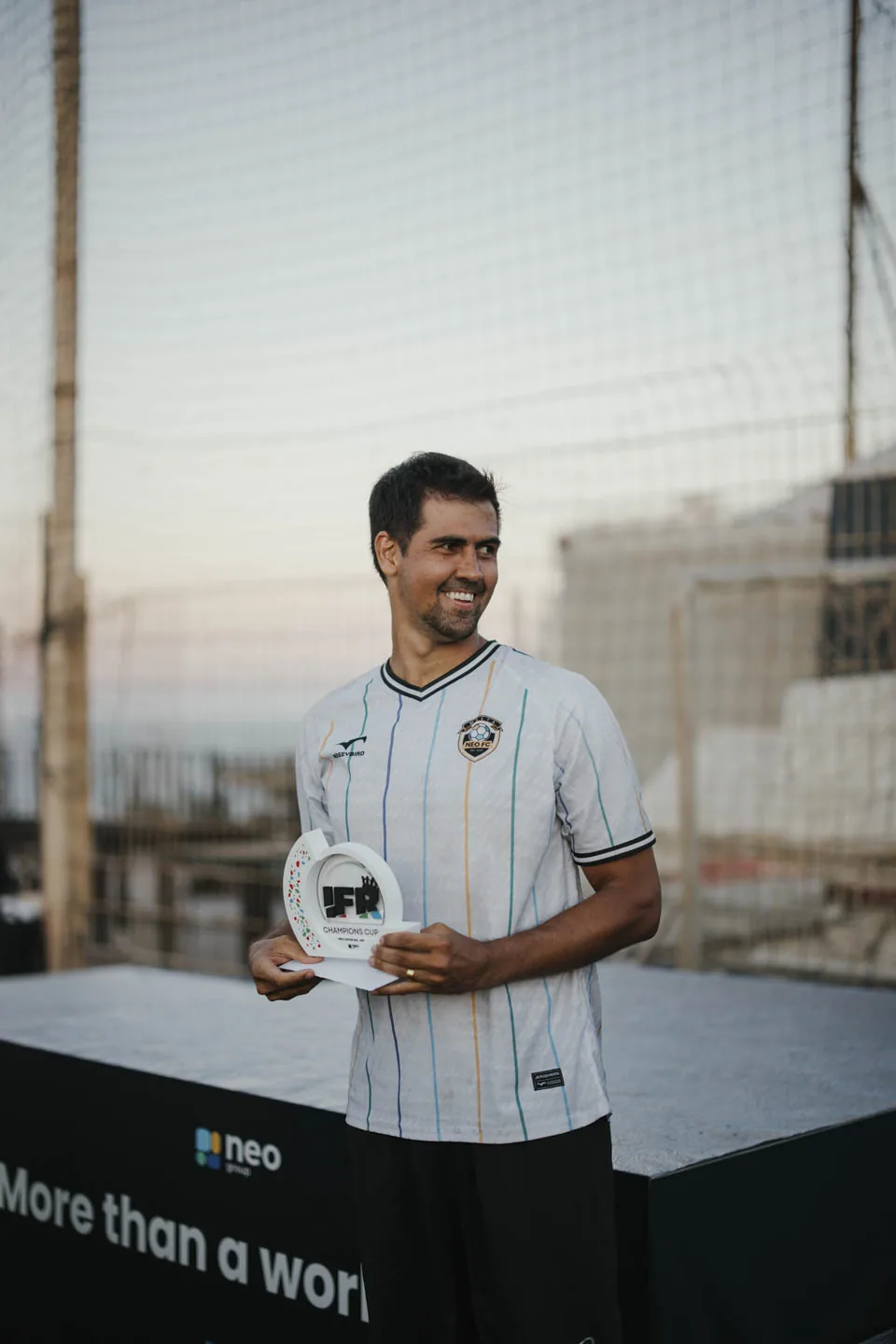 A NEO Group player holding his individual award at the 2026 Champions Cup