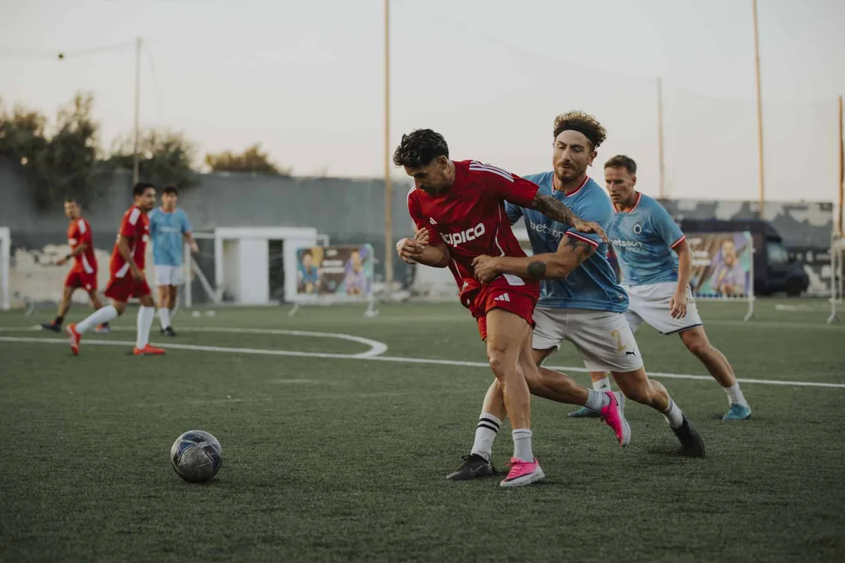 A Tipico player in red contests possession against Betsson at the 2026 Champions Cup