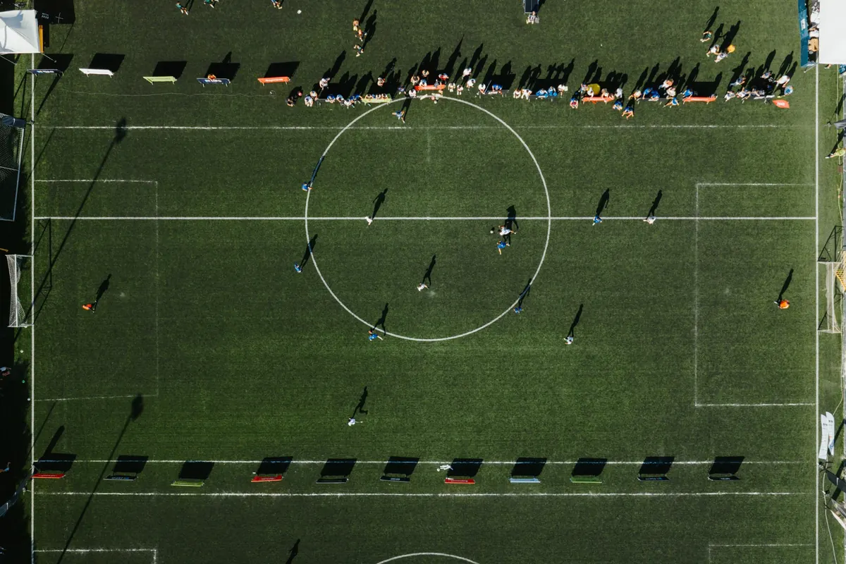 Aerial view of an IFR football pitch with spectators along both touchlines