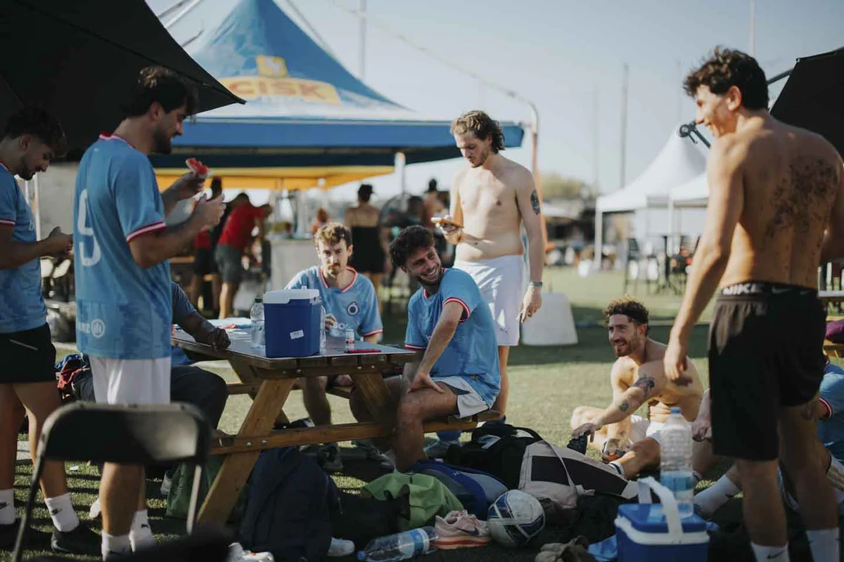 Colleagues sharing a break around a picnic table at IFR Champions Cup 2026