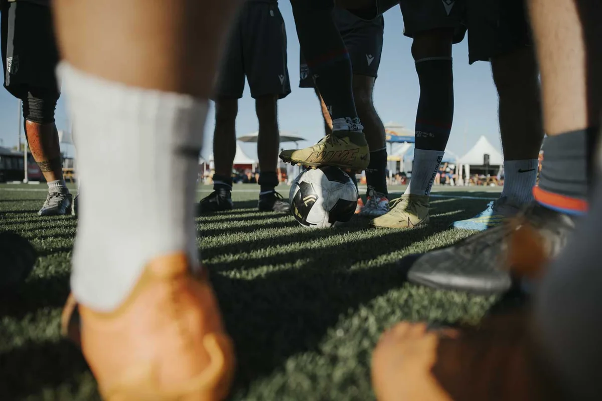 Players gather around a football at an IFR tournament