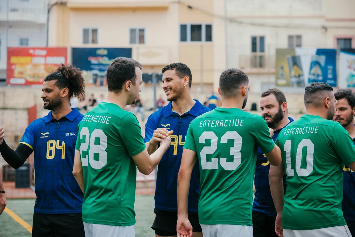 Enteractive and Neo Group players greet each other before the 2025/26 final