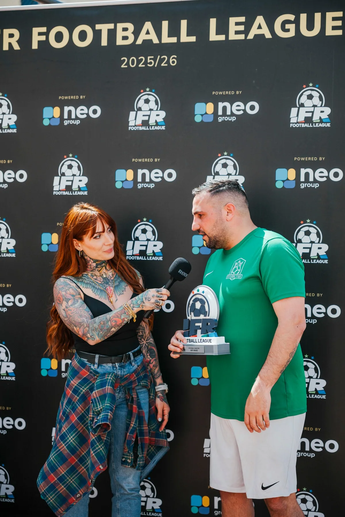An Enteractive player is interviewed in front of the sponsor press wall