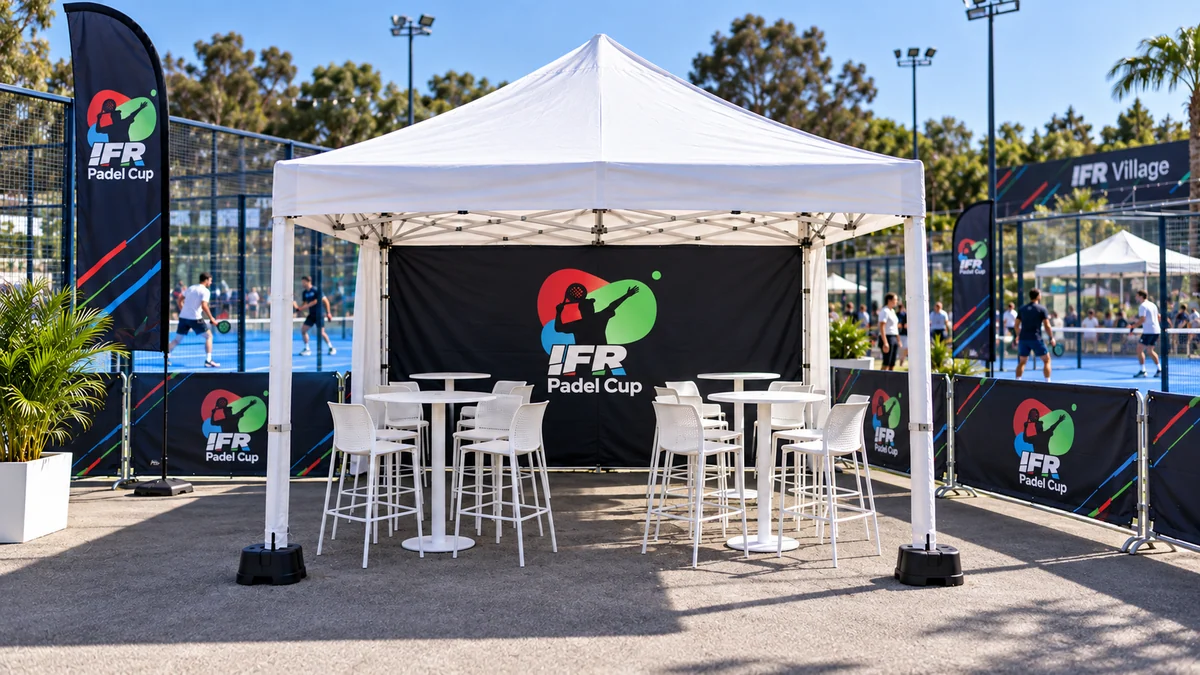 4m × 4m branded gazebo with tables and seating beside the padel courts