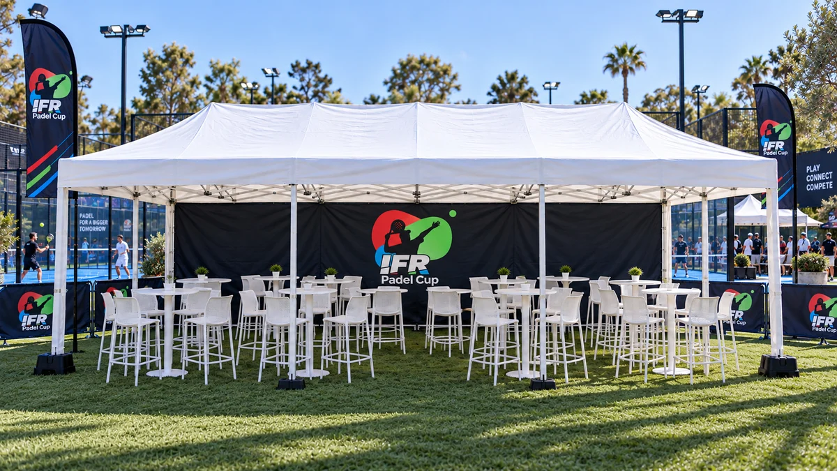 8m × 4m branded gazebo with a wide backdrop, tables and seating beside the padel courts